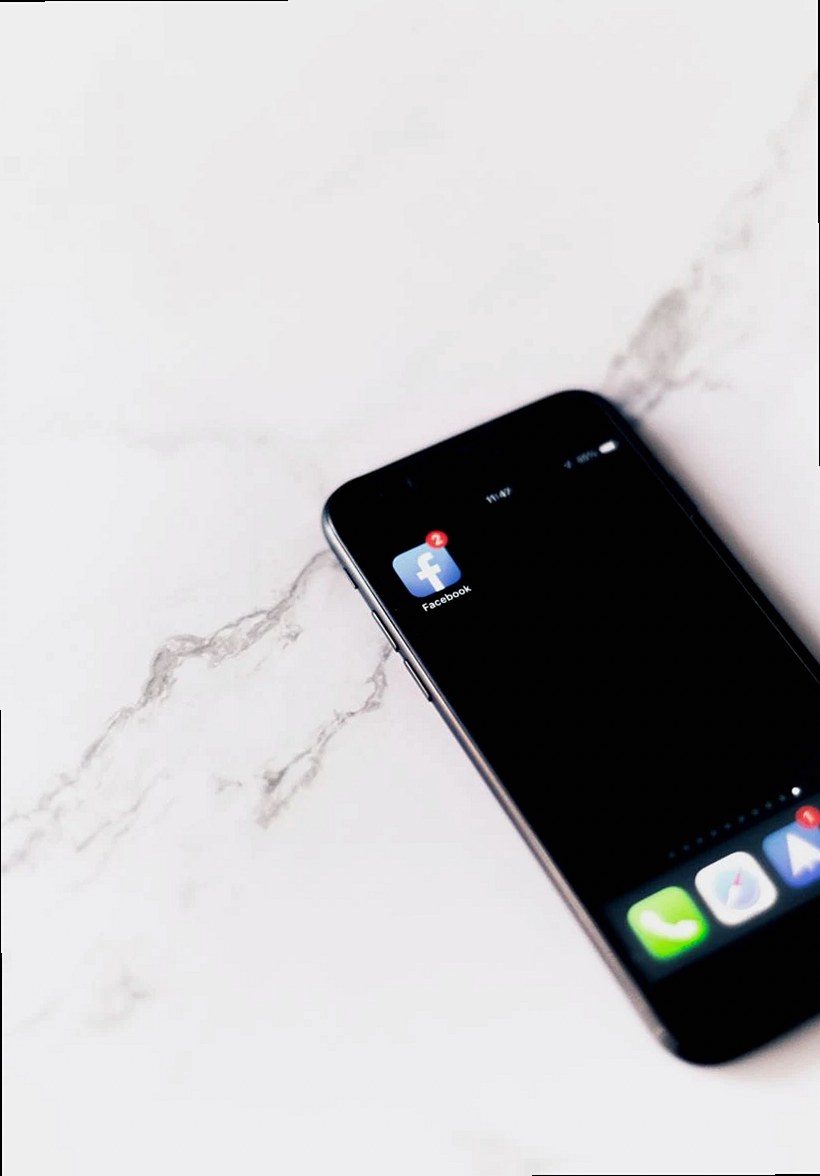 A smartphone displays a Facebook app notification on a clean white surface.